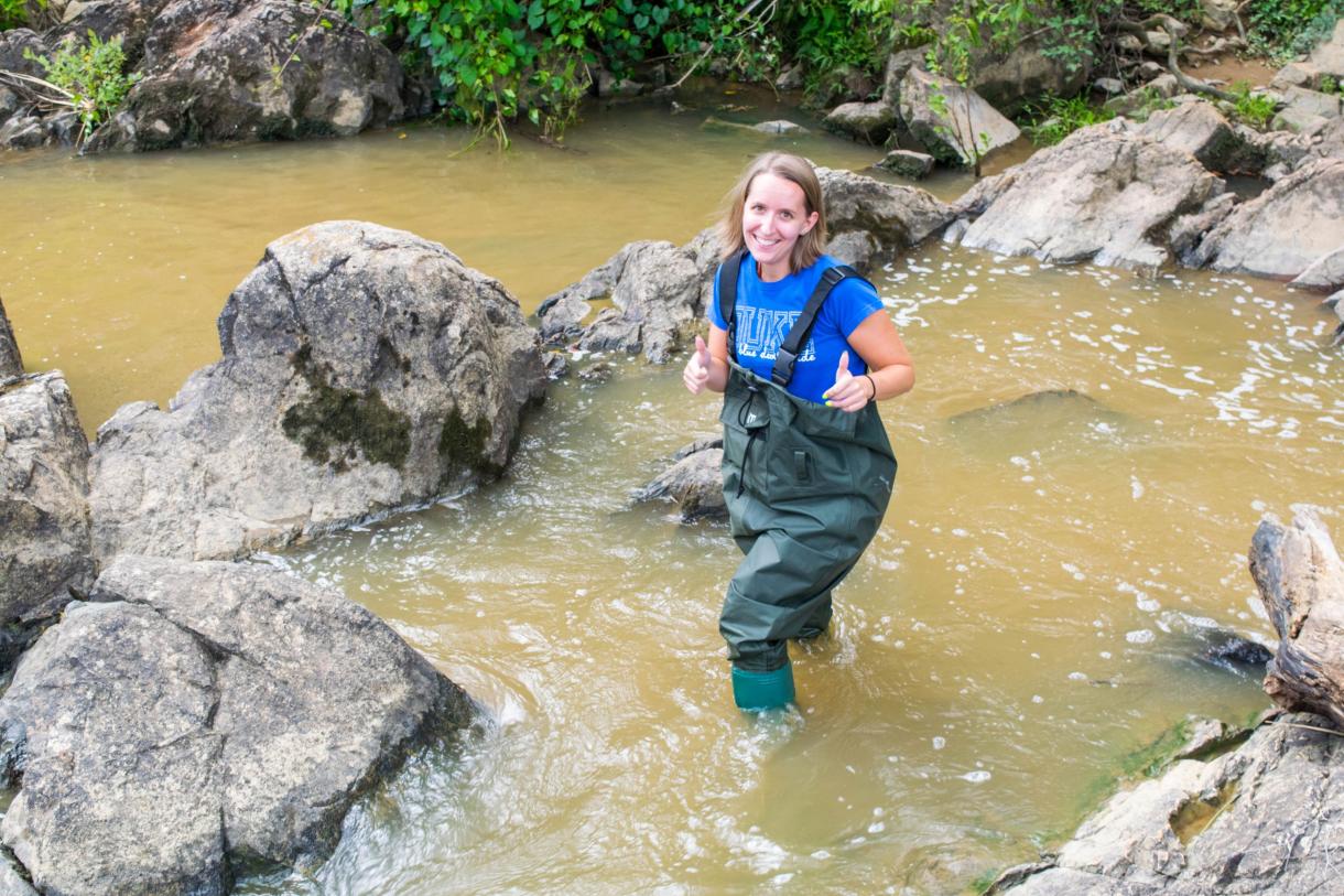 Ph.D. student Sam Hall collecting water samples from the Haw River