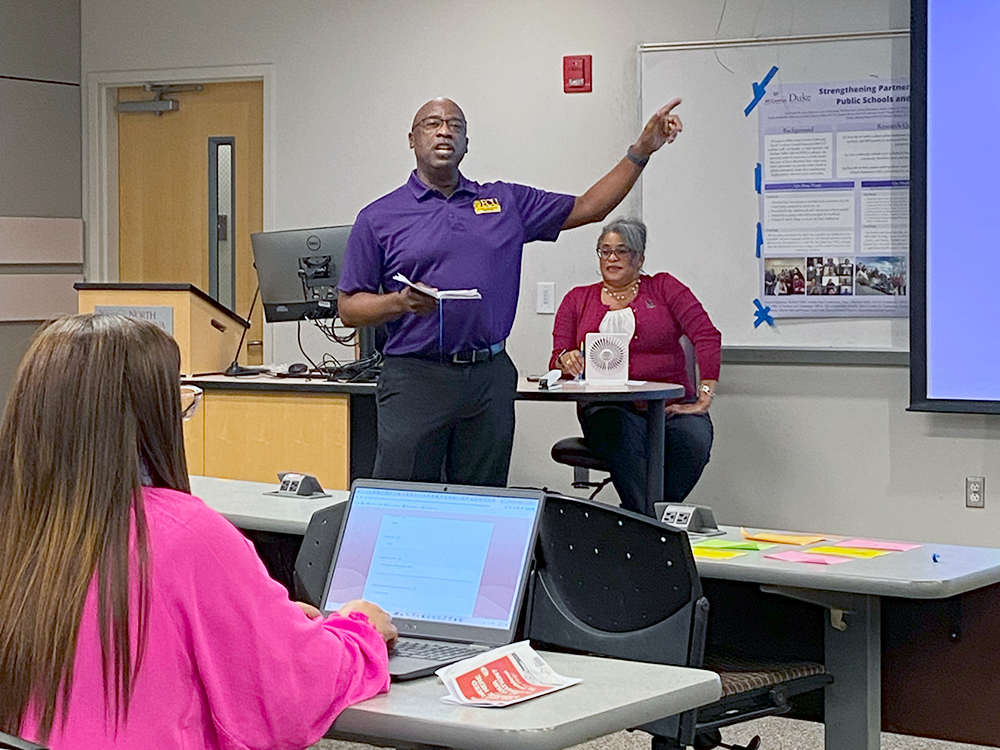 Hipp Barclift gestures during his presentation while Yolanda Dunston and others look on.