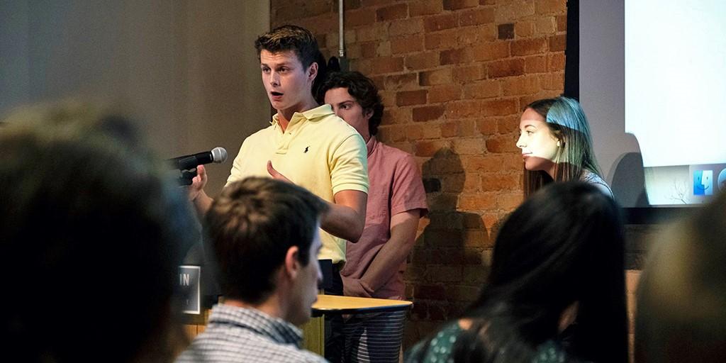 A man speaks in a mic to an audience