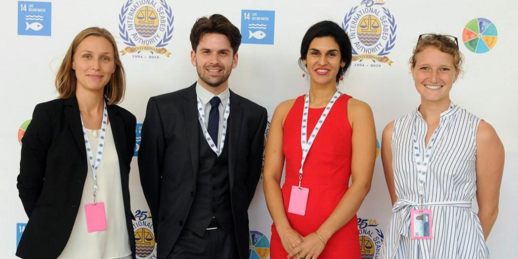 4 people smiling in formal attire