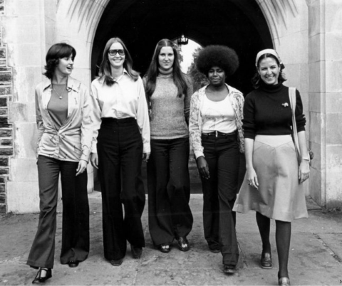 Black and white photo of five female students walking on Duke's campus in 1976.