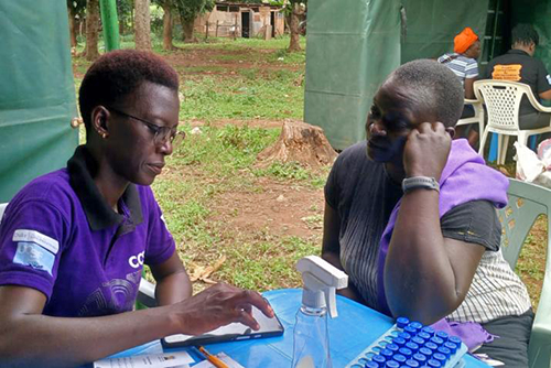 A global health researcher works with a smartphone.